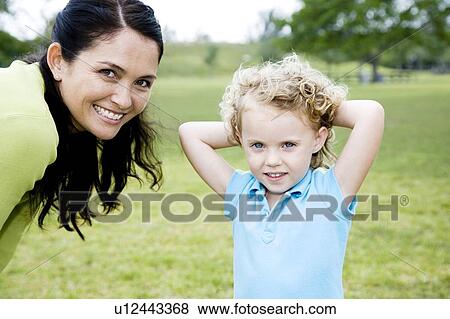 mother and daughter posing for photograph in the park View Large Photo Image Stock Photo - mother and daughter posing for photograph in the park. Fotosearch