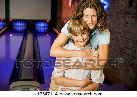 Mother and son in a bowling alley View Large Photo Image Picture - Mother and son in a bowling alley. Fotosearch