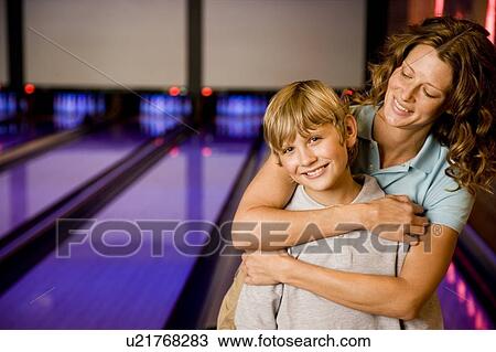 Stock Image - Mother and son in a bowling alley. Fotosearch