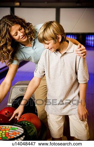 Stock Photo - Mother and son in a bowling alley . Fotosearch