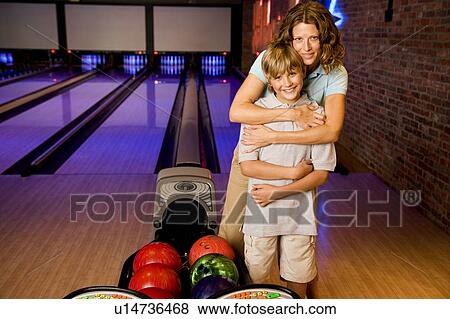 Mother and son in a bowling alley View Large Photo Image Stock Photo - Mother and son in a bowling alley. Fotosearch