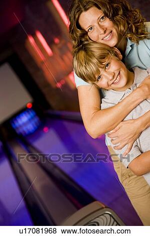 Mother and son in a bowling alley View Large Photo Image Stock Photo - Mother and son in a bowling alley. Fotosearch
