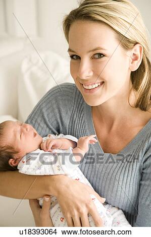 Mother holding her young baby View Large Photo Image Picture - Mother holding her young baby. Fotosearch