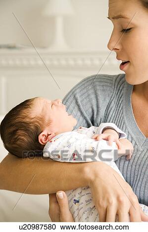 Mother holding her young baby View Large Photo Image Stock Image - Mother holding her young baby. Fotosearch
