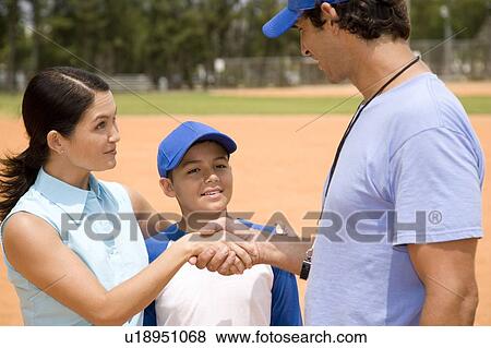 Stock Photo - mother meeting her son's baseball coach. Fotosearch