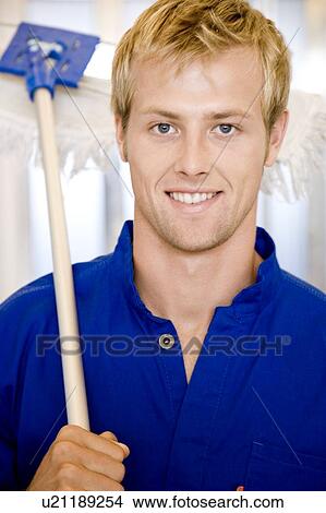 Picture - Office janitor or cleaning man with a broom or mop. Fotosearch