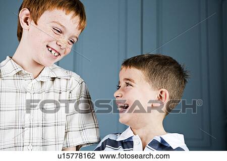 Older and younger boy laughing together View Large Photo Image Stock Image - Older and younger boy laughing together. Fotosearch