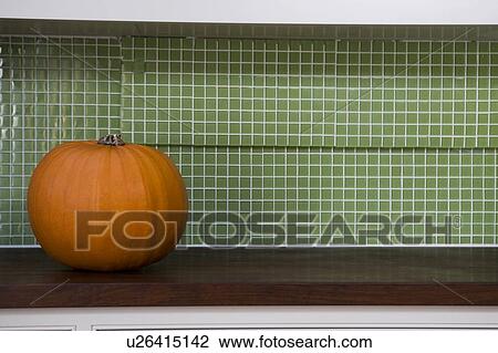 Orange Hallowe'en pumpkin on a kitchen counter View Large Photo Image Stock Image - Orange Hallowe'en pumpkin on a kitchen counter. Fotosearch