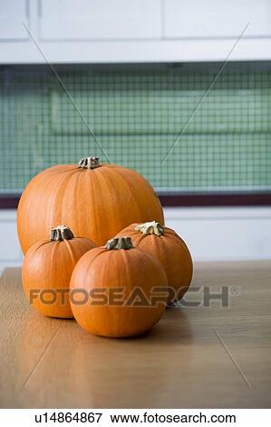 Stock Photo - Orange Hallowe'en pumpkins on a kitchen table. Fotosearch