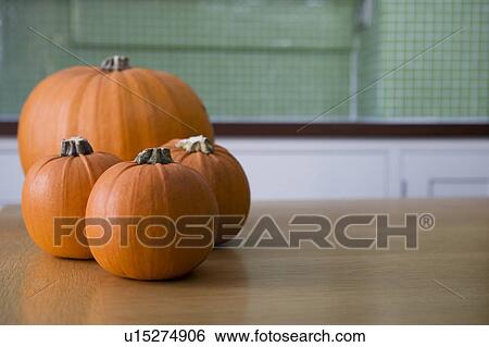 Orange Hallowe'en pumpkins on a kitchen table View Large Photo Image Stock Photograph - Orange Hallowe'en pumpkins on a kitchen table. Fotosearch