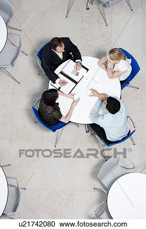 Overhead view of informal business meeting at table of staff canteen View Large Photo Image Stock Image - Overhead view of informal business meeting at table of staff canteen. Fotosearch