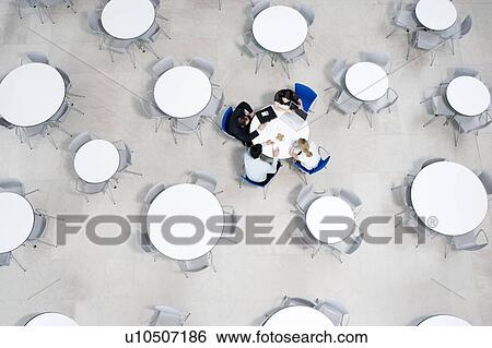 Overhead view of informal business meeting at table of staff canteen View Large Photo Image Stock Photograph - Overhead view of informal business meeting at table of staff canteen. Fotosearch