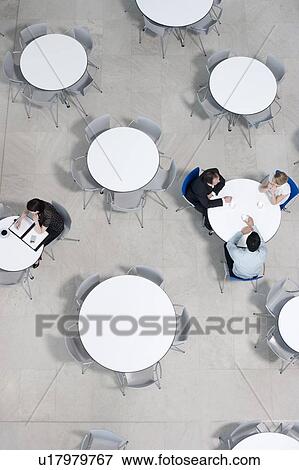 Overhead view of office workers at tables in the staff canteen View Large Photo Image Stock Photo - Overhead view of office workers at tables in the staff canteen. Fotosearch