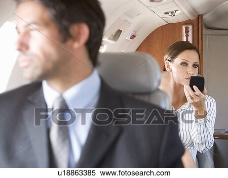 Passengers relaxing on a flight View Large Photo Image Stock Photography - Passengers relaxing on a flight. Fotosearch