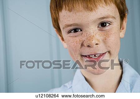 Picture - portrait boy with ginger hair and freckles smiling. Fotosearch