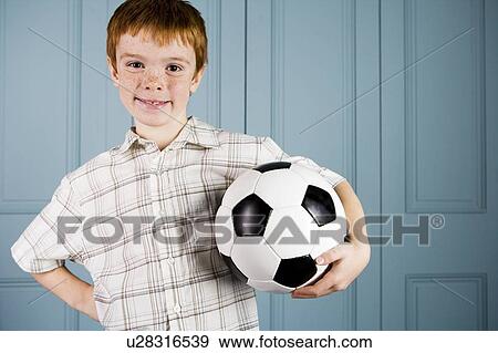 Stock Photo - portrait happy little boy holding football. Fotosearch