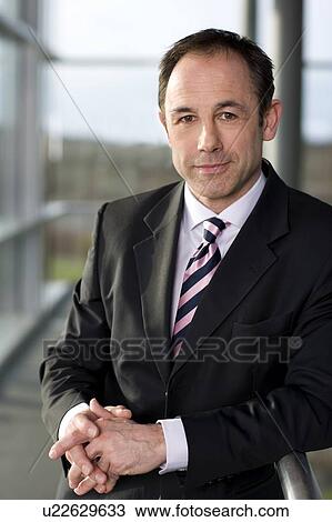 Portrait of a businessman in a smart suit View Large Photo Image Stock Image - Portrait of a businessman in a smart suit. Fotosearch