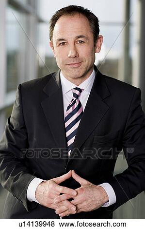 Portrait of a businessman in a smart suit View Large Photo Image Stock Photo - Portrait of a businessman in a smart suit. Fotosearch