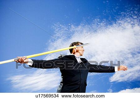 Portrait of a businessman throwing a javelin View Large Photo Image Picture - Portrait of a businessman throwing a javelin. Fotosearch