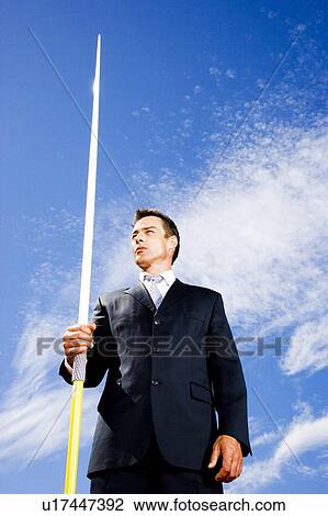 Portrait of a businessman throwing a javelin View Large Photo Image Stock Image - Portrait of a businessman throwing a javelin. Fotosearch