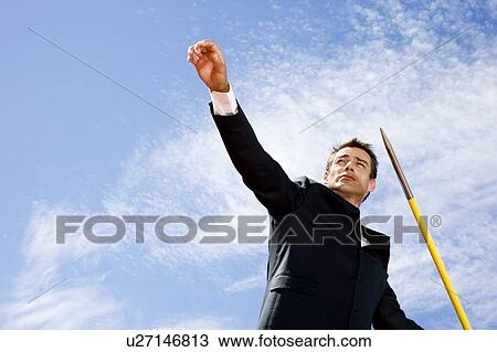 Portrait of a businessman throwing a javelin View Large Photo Image Stock Image - Portrait of a businessman throwing a javelin. Fotosearch