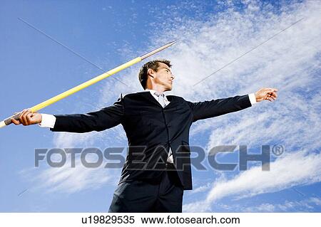 Portrait of a businessman throwing a javelin View Large Photo Image Stock Photography - Portrait of a businessman throwing a javelin. Fotosearch