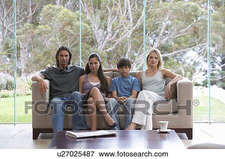 Portrait of a family sitting on a sofa View Large Photo Image Stock Photo - Portrait of a family sitting on a sofa. Fotosearch