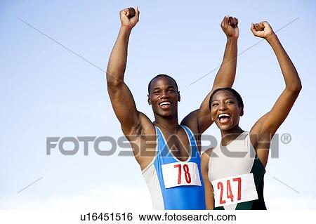 Portrait of a female and athletes with their arms in the air View Large Photo Image Stock Photograph - Portrait of a female and athletes with their arms in the air. Fotosearch