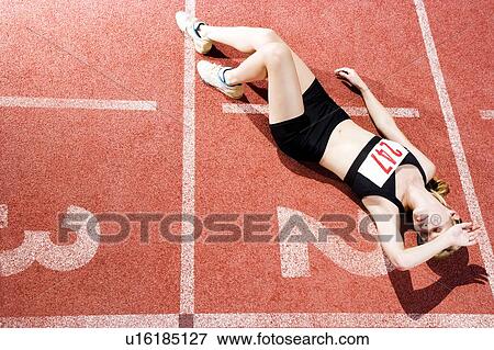 Portrait of a female athlete resting and sitting on the running track View Large Photo Image Stock Photo - Portrait of a female athlete resting and sitting on the running track. Fotosearch