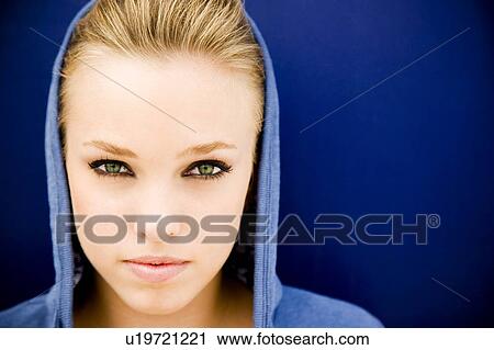 Portrait of a girl leaning against a blue painted wall View Large Photo Image Stock Image - Portrait of a girl leaning against a blue painted wall. Fotosearch