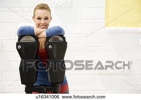 Portrait of a girl leaning against a traffic meter View Large Photo Image Stock Photograph - Portrait of a girl leaning against a traffic meter. Fotosearch