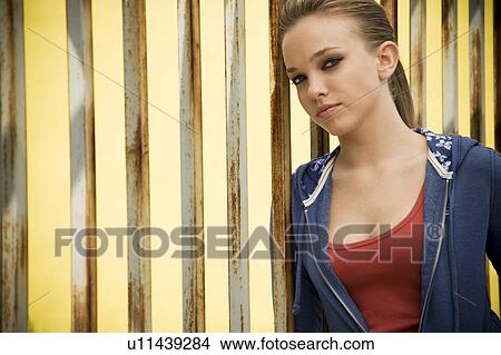 Portrait of a girl leaning against railing bars View Large Photo Image Picture - Portrait of a girl leaning against railing bars. Fotosearch