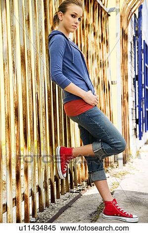 Portrait of a girl leaning against railing bars View Large Photo Image Stock Photography - Portrait of a girl leaning against railing bars. Fotosearch