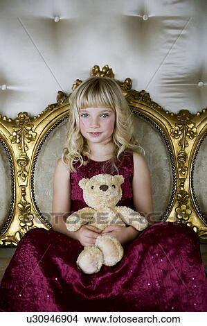 Portrait of a little girl holding a teddy bear View Large Photo Image Picture - Portrait of a little girl holding a teddy bear. Fotosearch