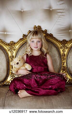 Portrait of a little girl holding a teddy bear View Large Photo Image Stock Photo - Portrait of a little girl holding a teddy bear. Fotosearch