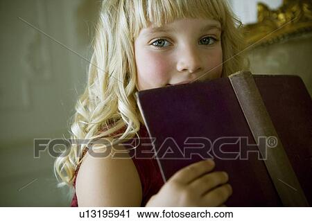 Portrait of a little girl reading a book View Large Photo Image Stock Image - Portrait of a little girl reading a book. Fotosearch