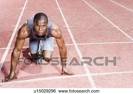 Portrait of a male athlete in the starting blocks View Large Photo Image Stock Photograph - Portrait of a male athlete in the starting blocks. Fotosearch