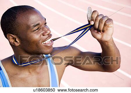 Portrait of a male athlete with his winning medal View Large Photo Image Stock Image - Portrait of a male athlete with his winning medal. Fotosearch