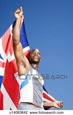 Stock Image - Portrait of a male athlete with UK flag. Fotosearch