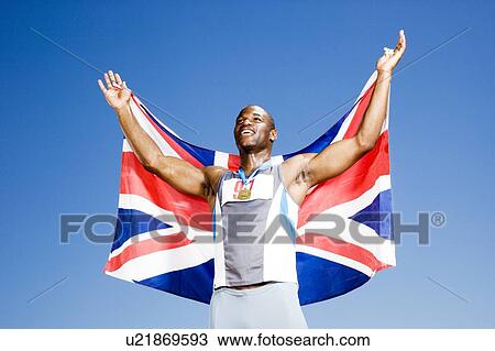 Stock Image - Portrait of a male athlete with UK flag. Fotosearch