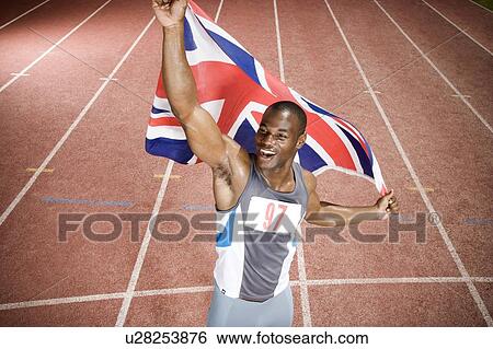Stock Photograph - Portrait of a male athlete with UK flag. Fotosearch