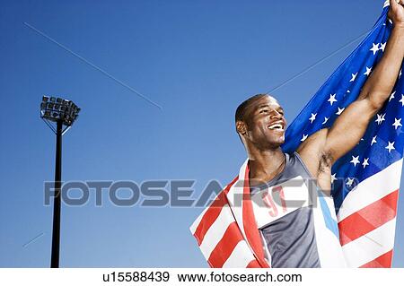 Stock Photo - Portrait of a male athlete with US flag. Fotosearch