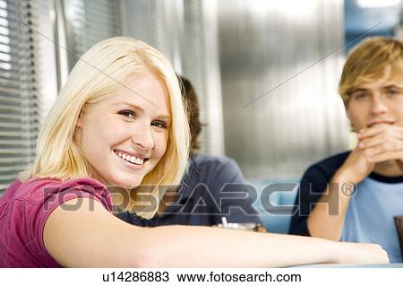 Portrait of a smiling teenage girl with her friends in a diner View Large Photo Image Stock Image - Portrait of a smiling teenage girl with her friends in a diner . Fotosearch