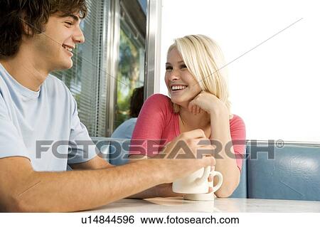 Portrait of a teenage couple flirting in a diner View Large Photo Image Stock Photograph - Portrait of a teenage couple flirting in a diner. Fotosearch