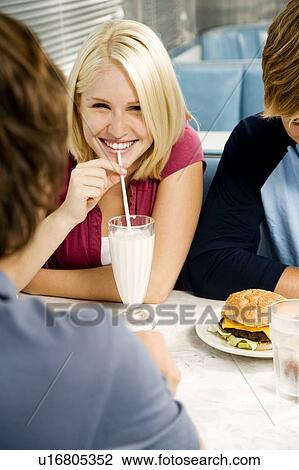 Portrait of a teenage girl drinking a milkshake View Large Photo Image Stock Image - Portrait of a teenage girl drinking a milkshake . Fotosearch