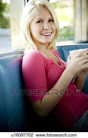 Stock Image - Portrait of a teenage girl hanging out at a diner. Fotosearch