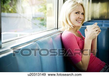 Stock Photo - Portrait of a teenage girl hanging out at a diner. Fotosearch