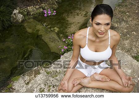 Portrait of a woman practicing yoga by a pond in an oriental garden View Large Photo Image Stock Photograph - Portrait of a woman practicing yoga by a pond in an oriental garden. Fotosearch