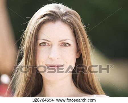Picture - Portrait of a woman with long brown hair. Fotosearch