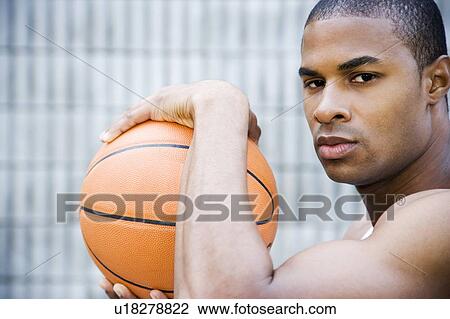 Portrait of a young African American man holding a basketball. View Large Photo Image Stock Image - Portrait of a young African American man holding a basketball. . Fotosearch